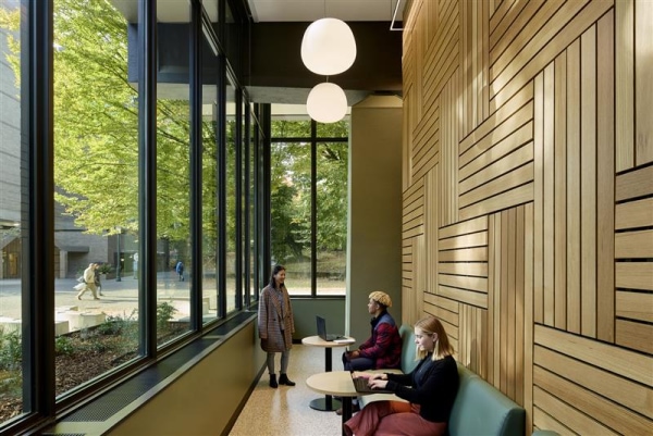 A student securing a bicycle outside the Simon Benson House